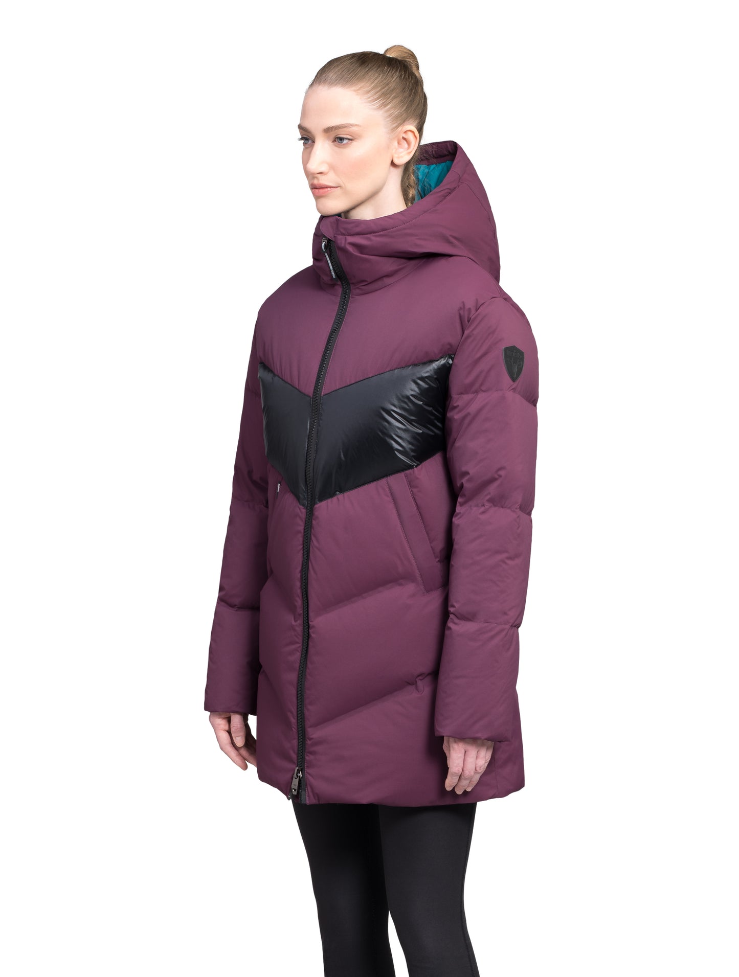 Isla Women's Chevron Quilted Puffer Jacket in thigh length, premium technical nylon taffeta fabrication, Premium Canadian origin White Duck Down insulation, non-removable down-filled hood, two-way centre-front zipper, zipper pockets at waist, contrast cire technical nylon taffeta detailing on chest and back, in Potent Purple