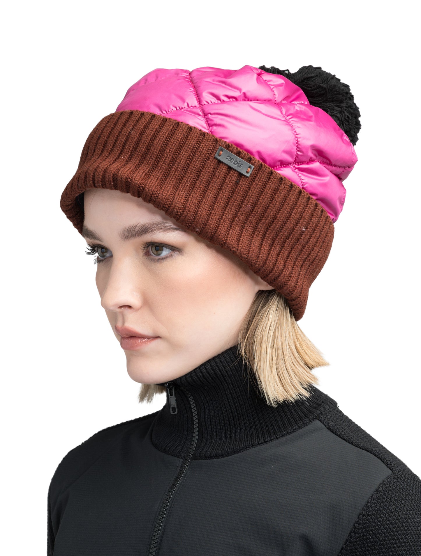 Lany Unisex Hybrid Pom Beanie in an extra fine merino wool blend and premium cire technical taffeta fabrication, rib knit cuff with leather Nobis wordmark detailing, quilted body, and plush pom-pom finish, in Festival Fuschia