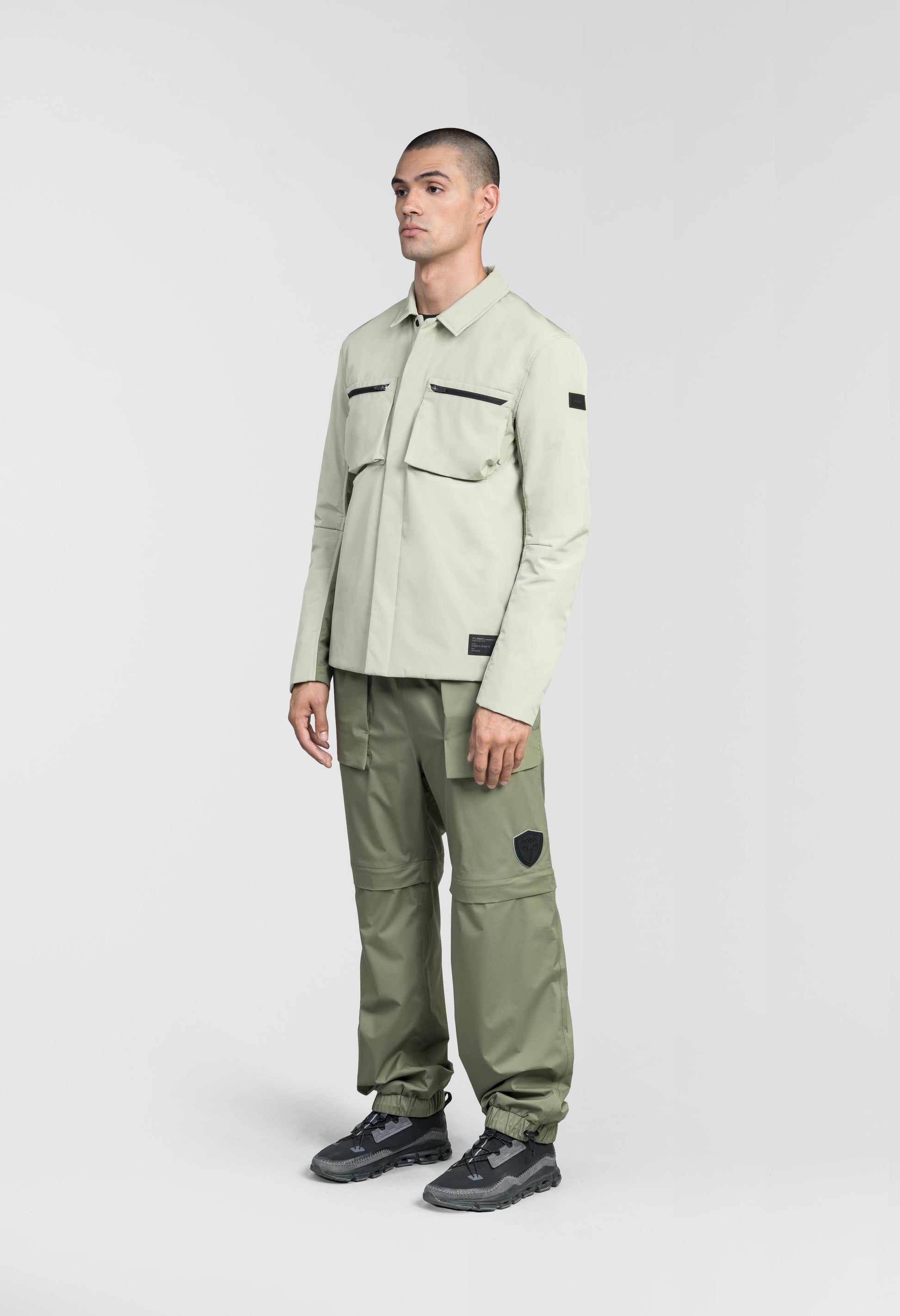 Ander Men's Mid Layer Shirt in hip length, PrimaLoft Gold Insulation Active+, 3-Ply Micro Denier front and 4-Way Durable Stretch Weave back, zipper chest pockets, snap button wind flap, and snap button cuffs, in Tea/Clover