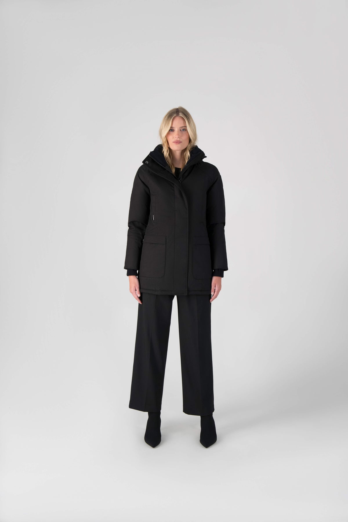 Women's down filled parka that sits just below the hip with a clean look and two hip patch pockets in Black