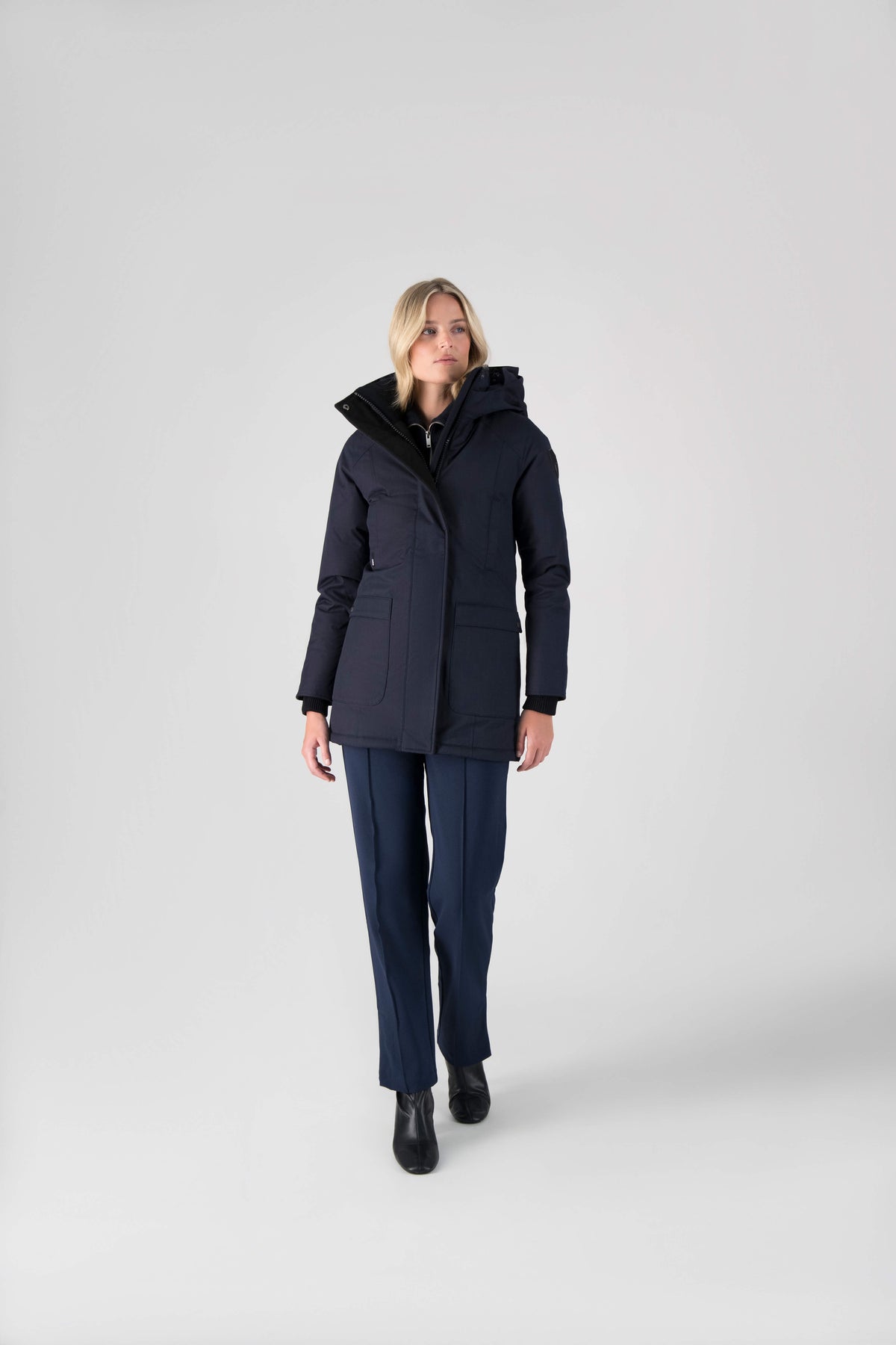 Women's down filled parka that sits just below the hip with a clean look and two hip patch pockets in Navy