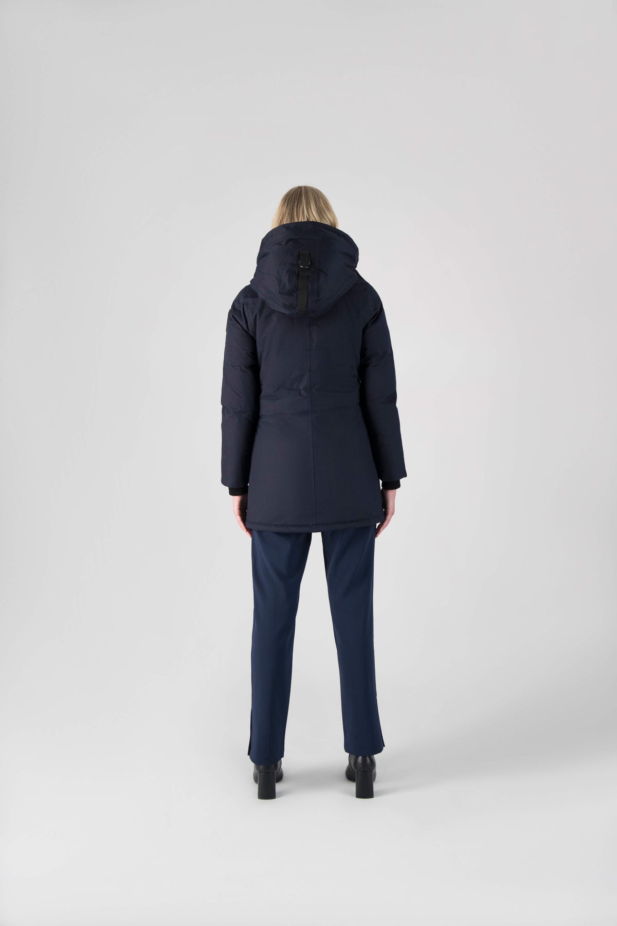 Women's down filled parka that sits just below the hip with a clean look and two hip patch pockets in Navy
