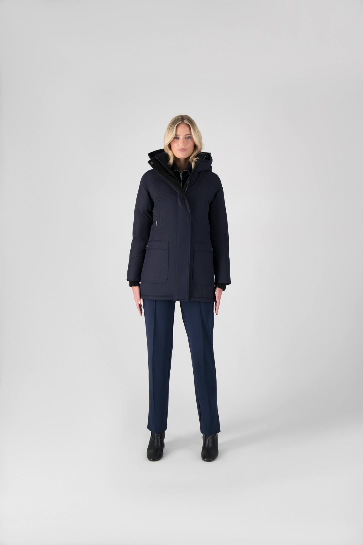 Women's down filled parka that sits just below the hip with a clean look and two hip patch pockets in Navy
