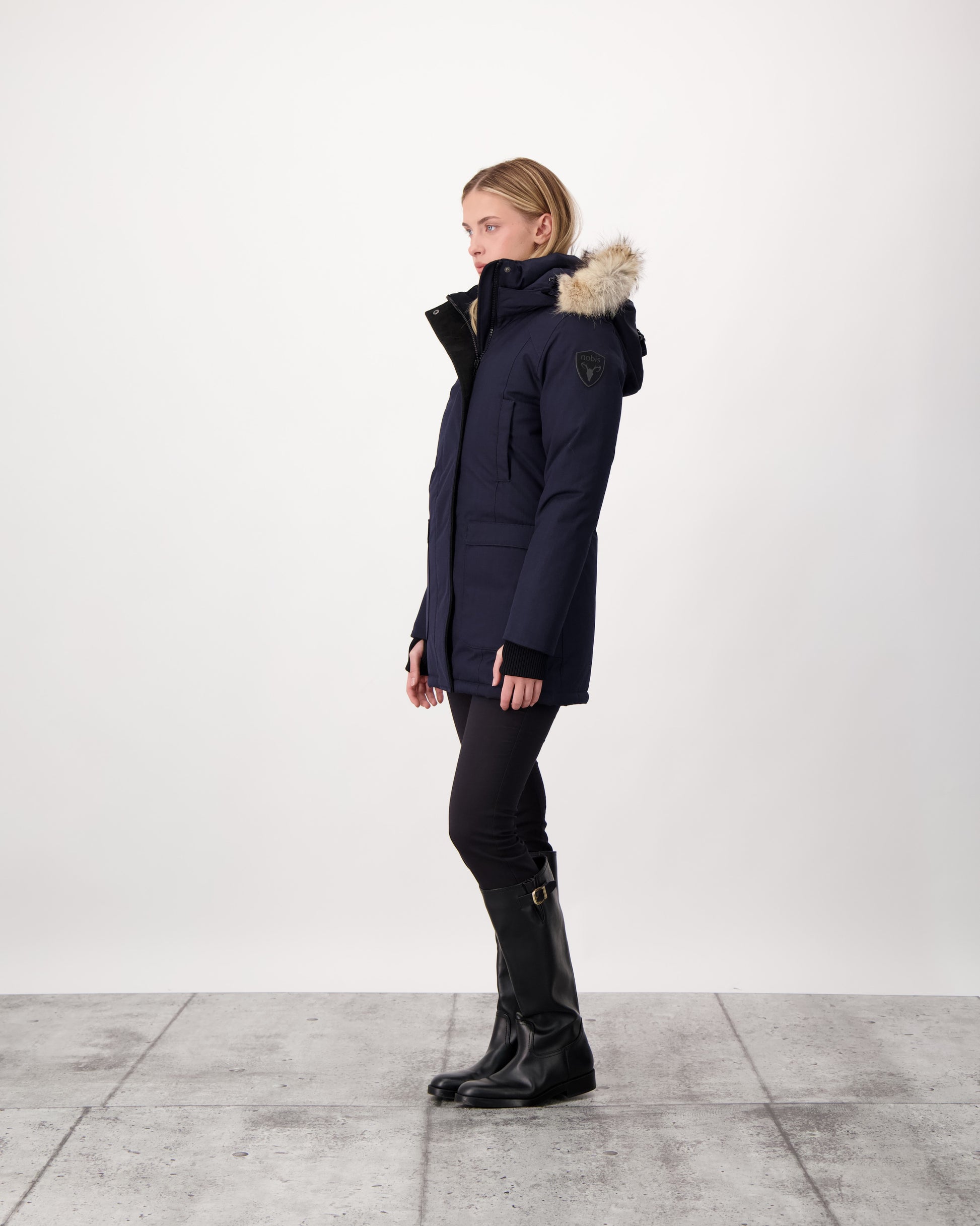 Women's down filled parka that sits just below the hip with a clean look and two hip patch pockets in Navy