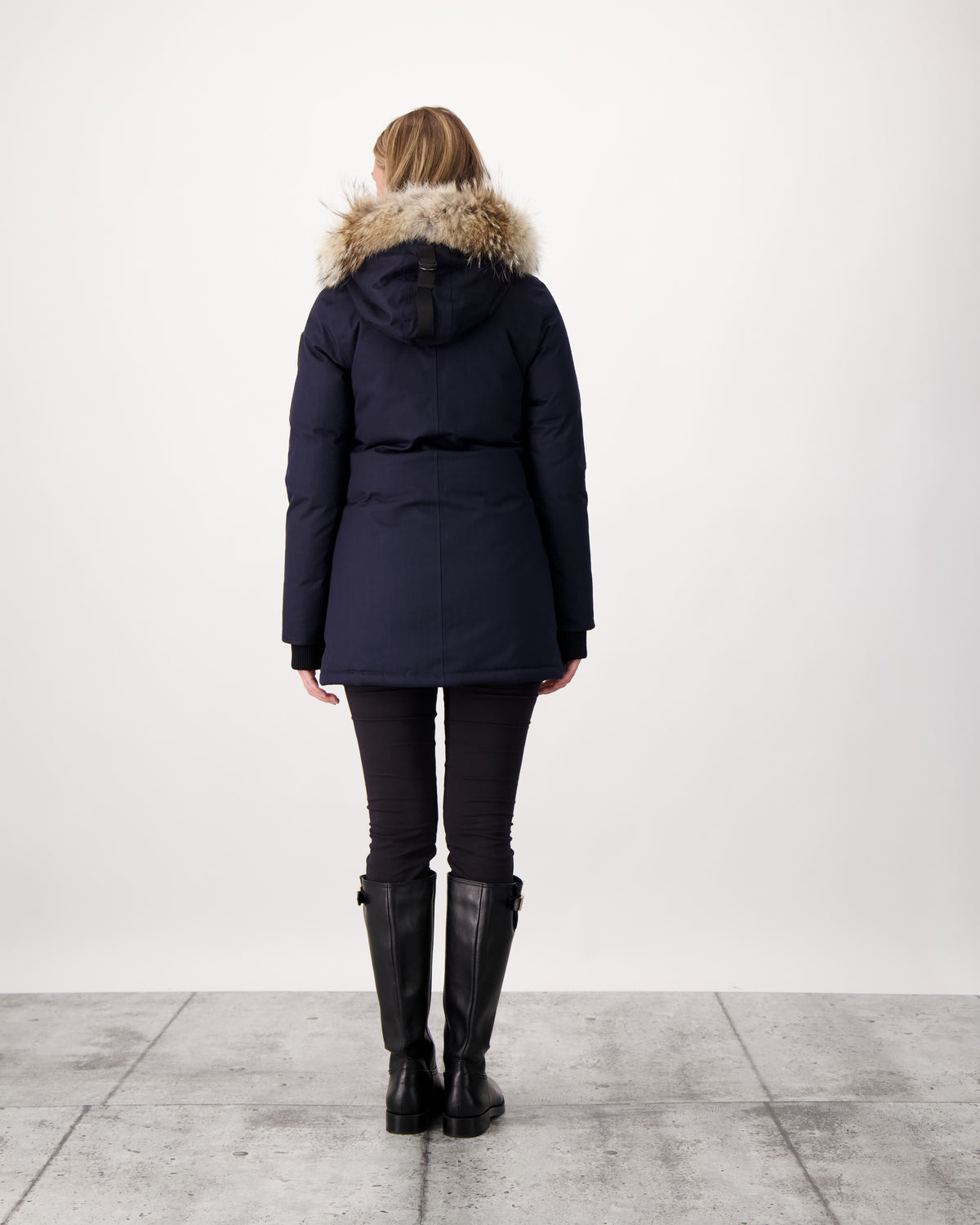 Women's down filled parka that sits just below the hip with a clean look and two hip patch pockets in Navy