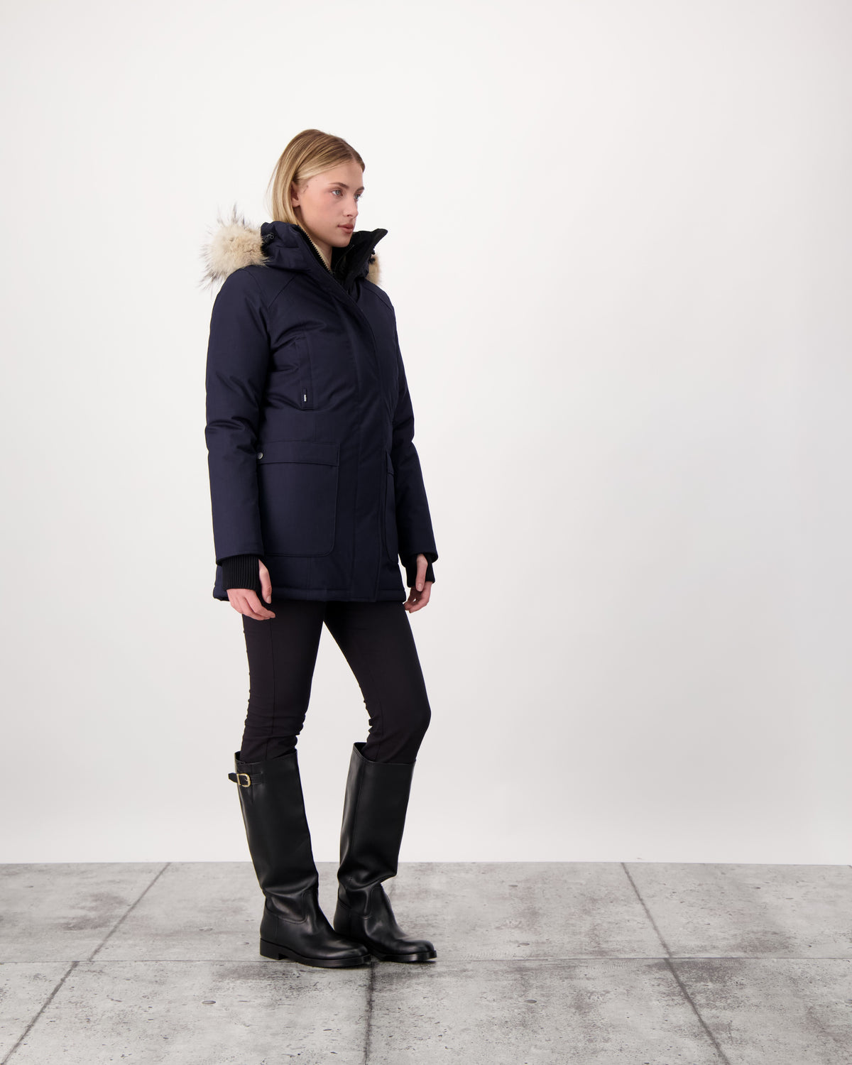 Women's down filled parka that sits just below the hip with a clean look and two hip patch pockets in Navy