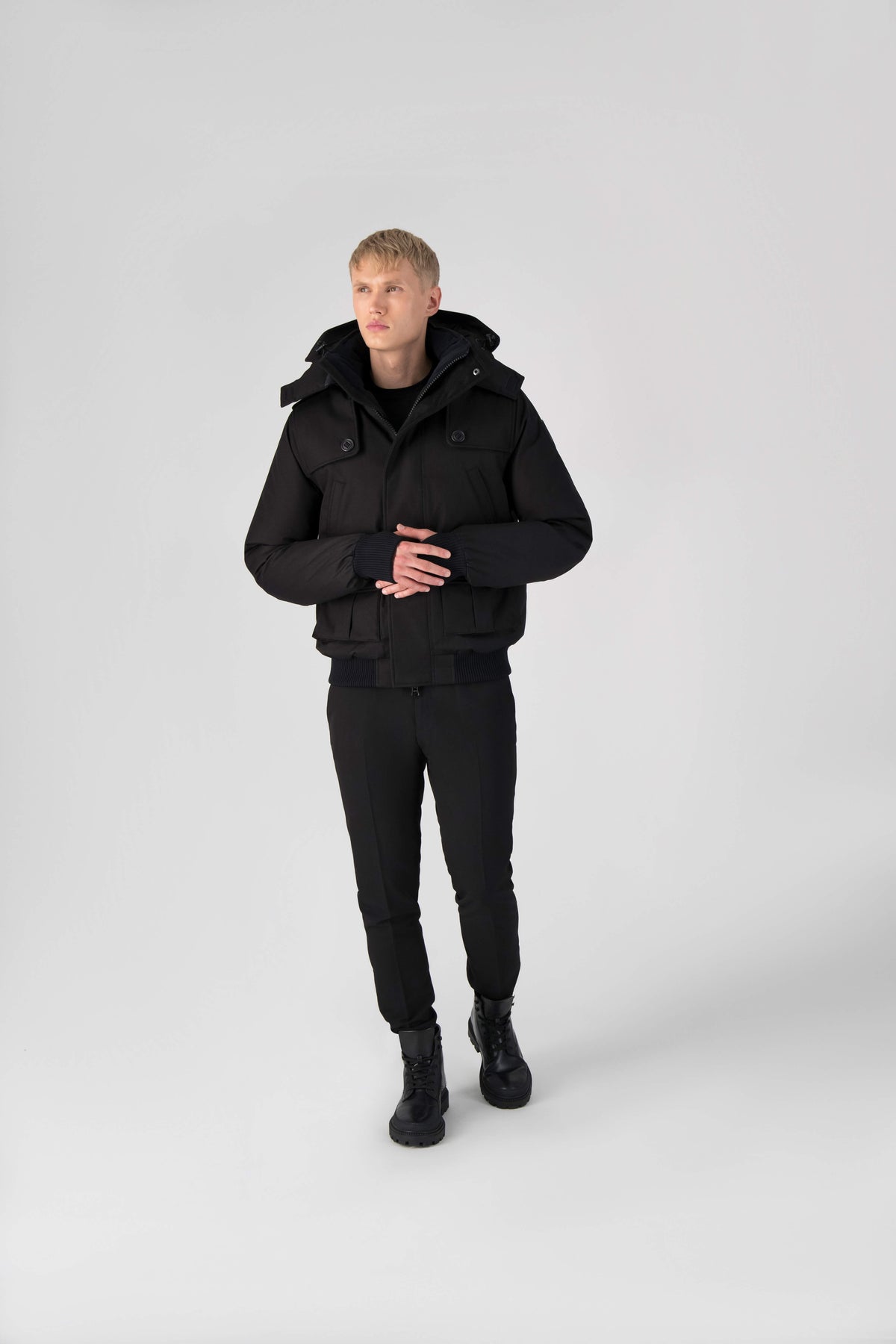 Men's down filled bomber that sits just above the hips with a completely removable hood that's windproof, waterproof, and breathable in Black