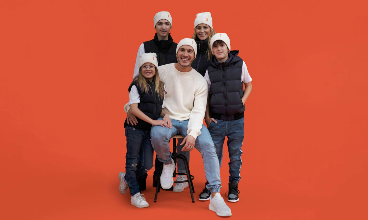 Portrait of Shawn Desman and his family on an orange backdrop.