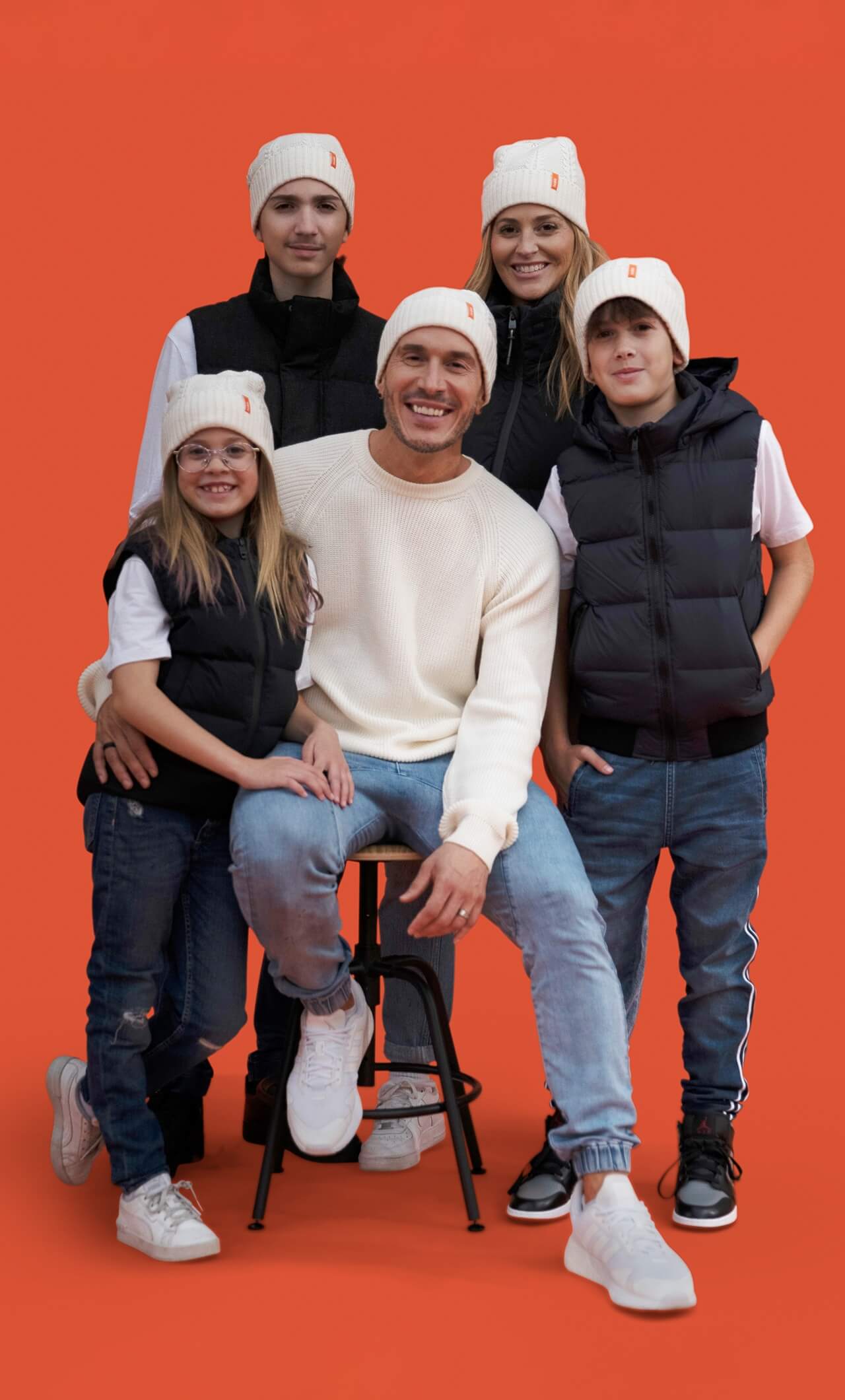 Portrait of Shawn Desman and his family on an orange backdrop.