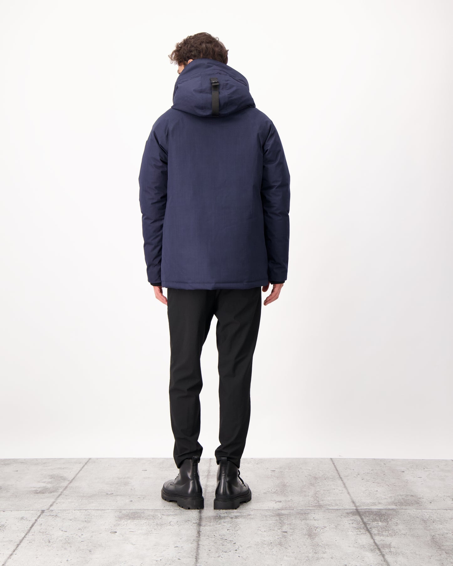 Men's waist length down filled jacket with two front pockets with magnetic closure and a removable fur trim on the hood in CH Navy