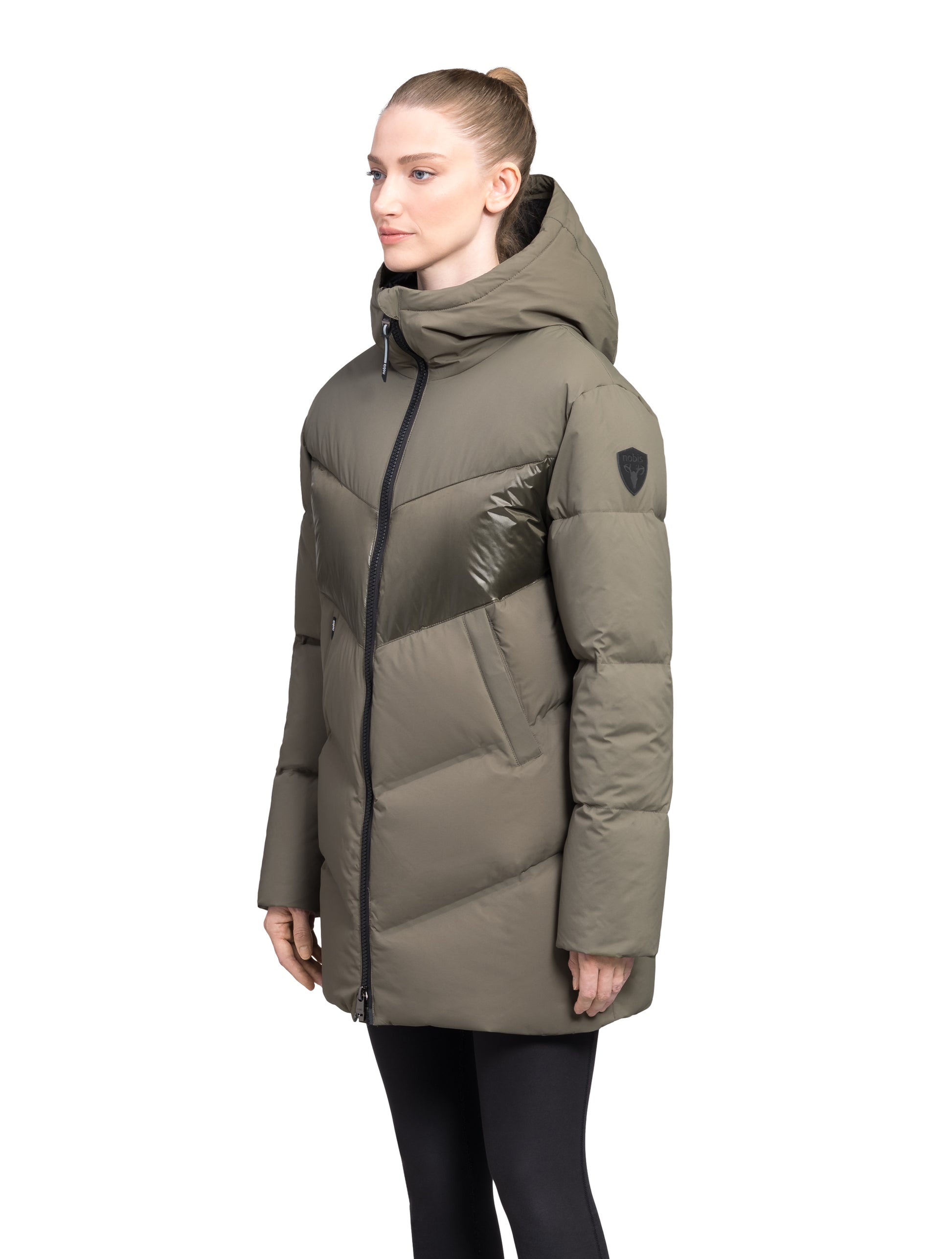 Isla Women's Chevron Quilted Puffer Jacket in thigh length, premium technical nylon taffeta fabrication, Premium Canadian origin White Duck Down insulation, non-removable down-filled hood, two-way centre-front zipper, zipper pockets at waist, contrast cire technical nylon taffeta detailing on chest and back, in Fatigue