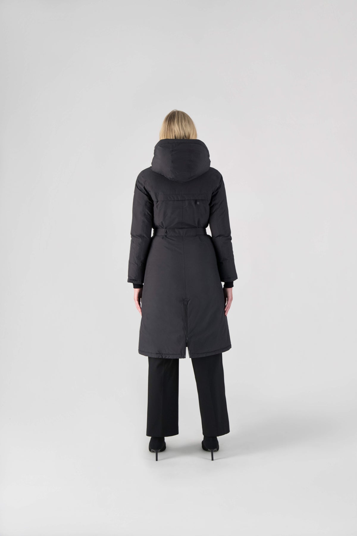Long calf length hooded women's winter parka with an inner hip length closure, exterior hem length zipper and magnetic placket in Black