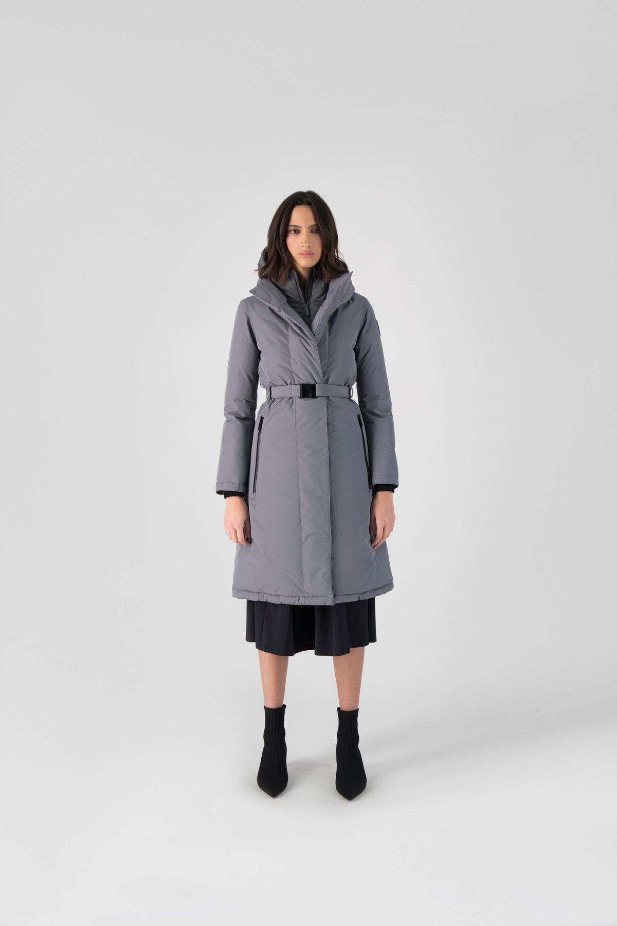 Long calf length hooded women's winter parka with an inner hip length closure, exterior hem length zipper and magentic placket in Concrete