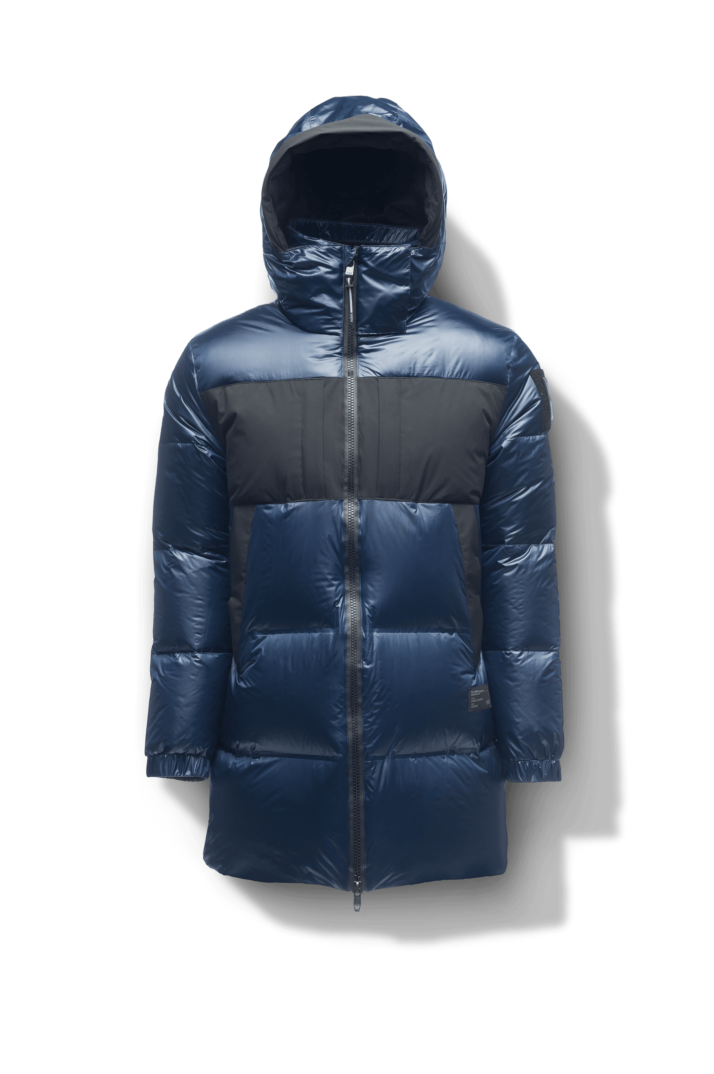 Neelix Men's Long Puffer Jacket in thigh length, premium cire technical nylon taffeta and stretch ripstop fabrication, Premium Canadian origin White Duck Down insulation, non-removable down-filled hood, two-way centre-front zipper, pit zipper vents, hidden chest zipper pockets, fleece-lined magnetic closure waist pockets, in Marine
