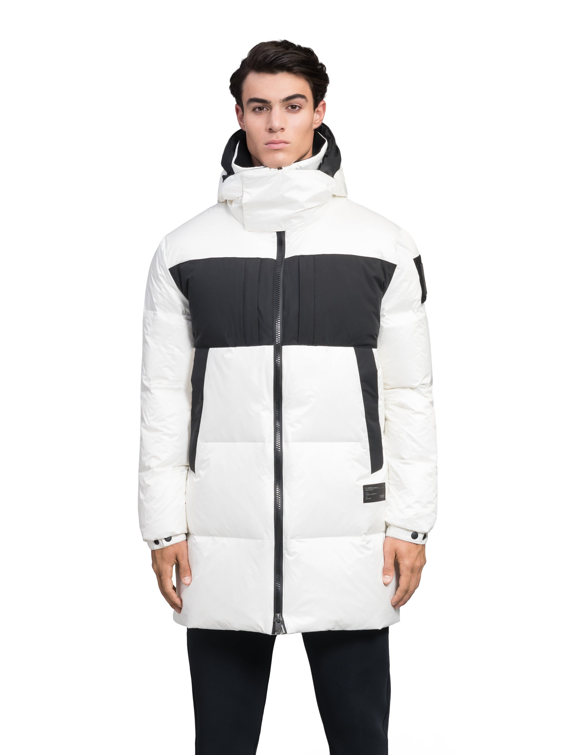 Neelix Men's Long Puffer Jacket in thigh length, premium cire technical nylon taffeta and stretch ripstop fabrication, Premium Canadian origin White Duck Down insulation, non-removable down-filled hood, two-way centre-front zipper, pit zipper vents, hidden chest zipper pockets, fleece-lined magnetic closure waist pockets, in Chalk