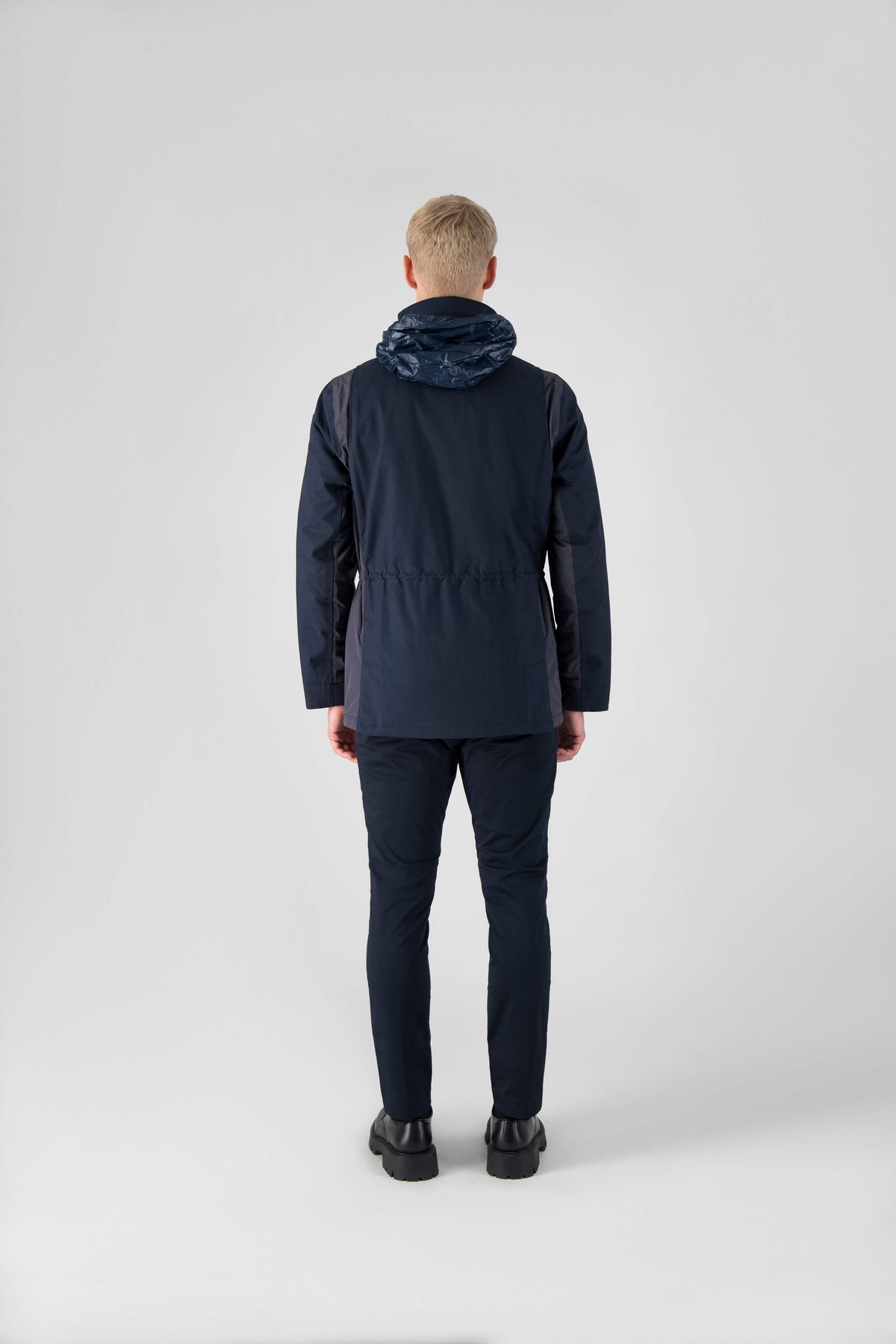 Pelican Men's Tailored Field Jacket in hip length, premium cotton blend and 3-ply micro denier fabrication, Premium Canadian origin White Duck Down insulation, tuck away, waterproof hood in premium cire technical nylon taffeta, two-way centre-front zipper with magnetic wind flap, pit zipper vents, magnetic closure chest and waist flap pockets, hidden adjustable waist drawcord, and action back detailing, in Navy