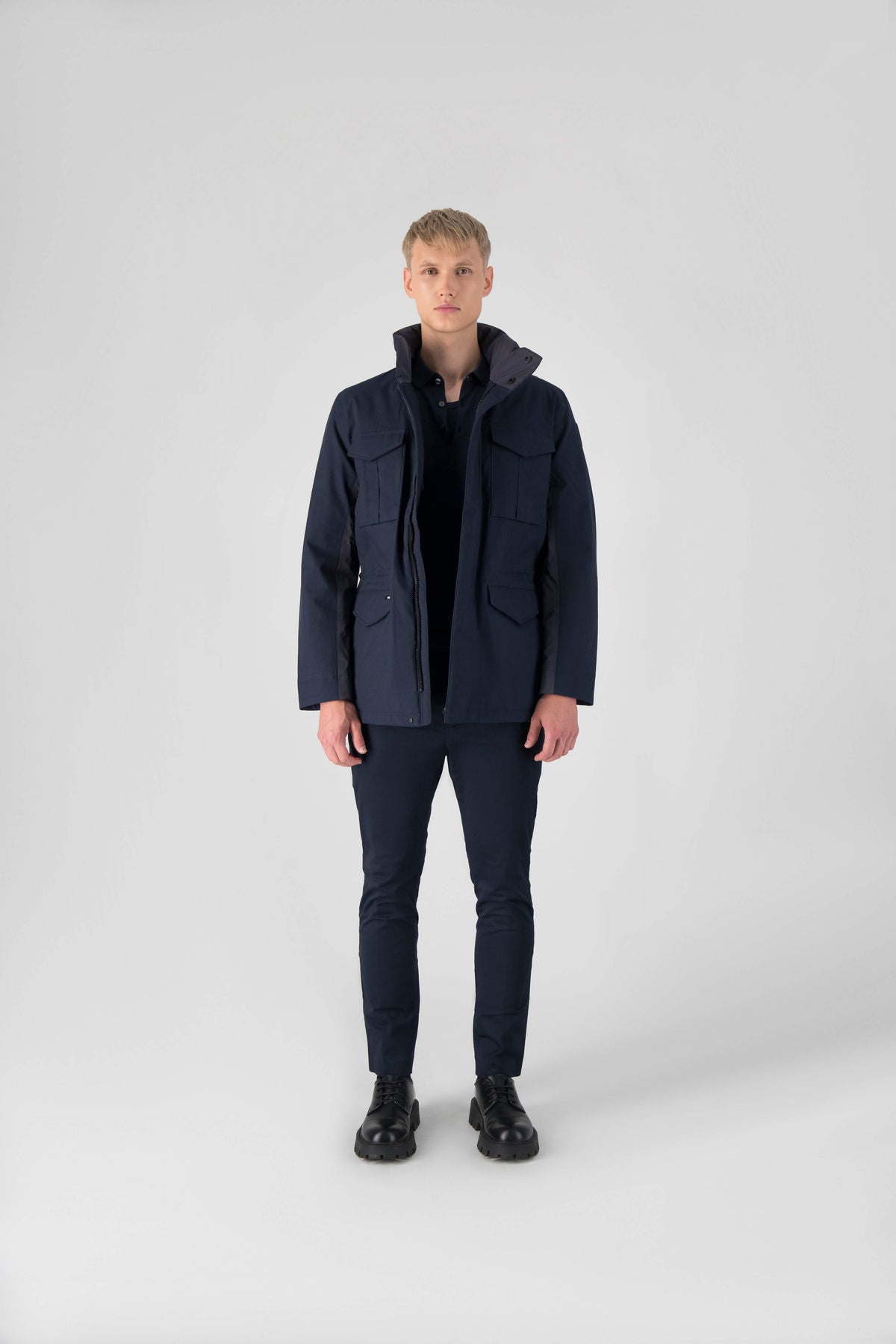 Pelican Men's Tailored Field Jacket in hip length, premium cotton blend and 3-ply micro denier fabrication, Premium Canadian origin White Duck Down insulation, tuck away, waterproof hood in premium cire technical nylon taffeta, two-way centre-front zipper with magnetic wind flap, pit zipper vents, magnetic closure chest and waist flap pockets, hidden adjustable waist drawcord, and action back detailing, in Navy