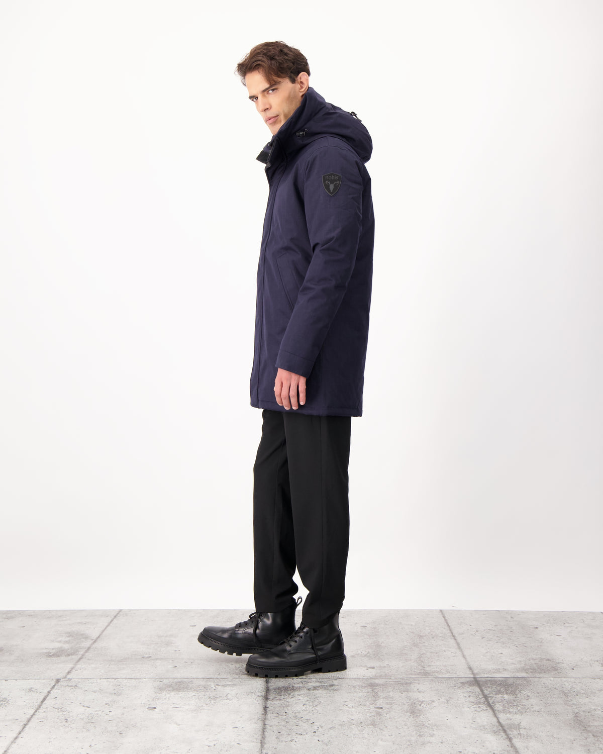 Pierre Men's Jacket in thigh length, Canadian white duck down insulation, non-removable down-filled hood, angled waist pockets, centre-front zipper with wind flap, and elastic ribbed cuffs, in CH Navy