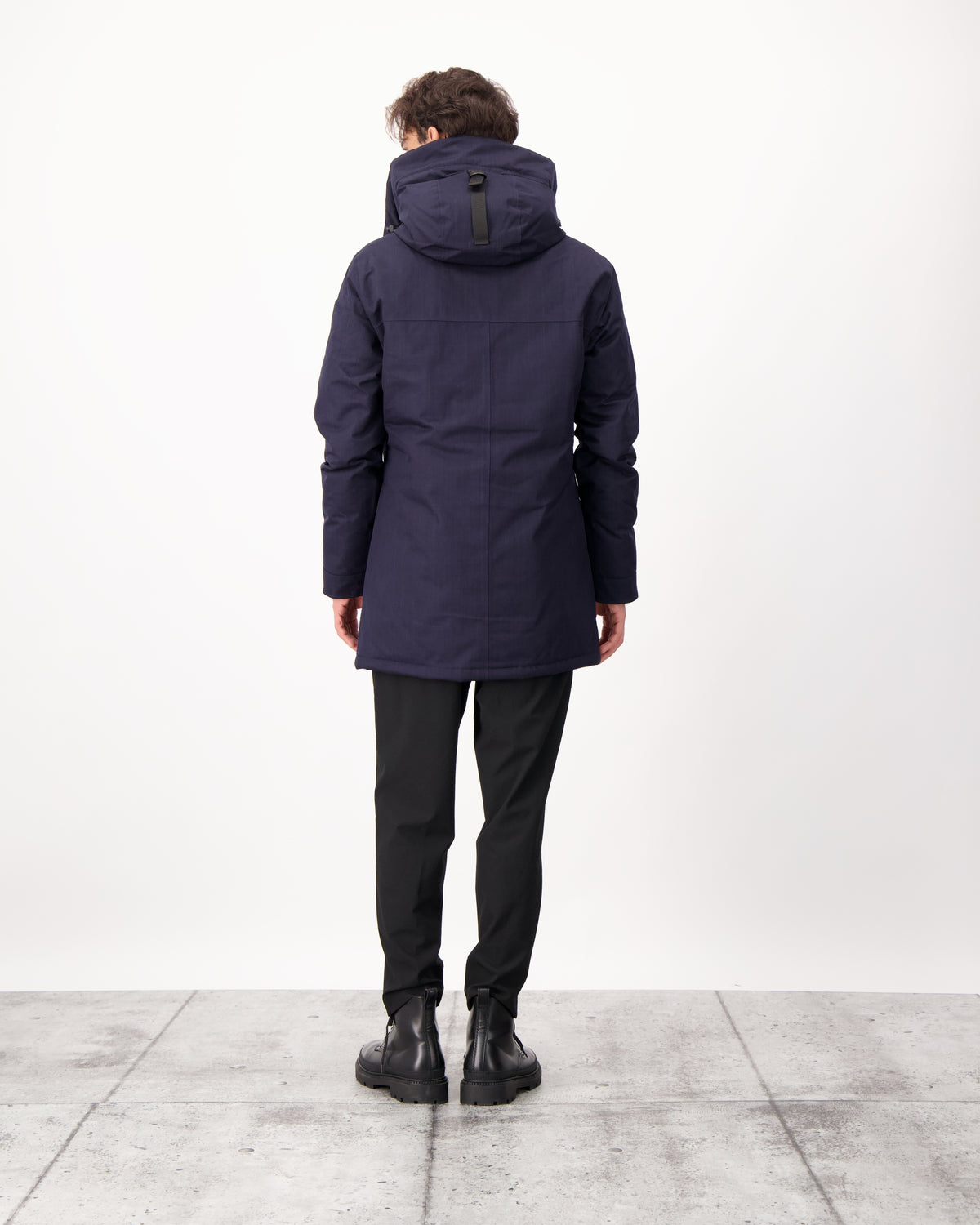 Pierre Men's Jacket in thigh length, Canadian white duck down insulation, non-removable down-filled hood, angled waist pockets, centre-front zipper with wind flap, and elastic ribbed cuffs, in CH Navy