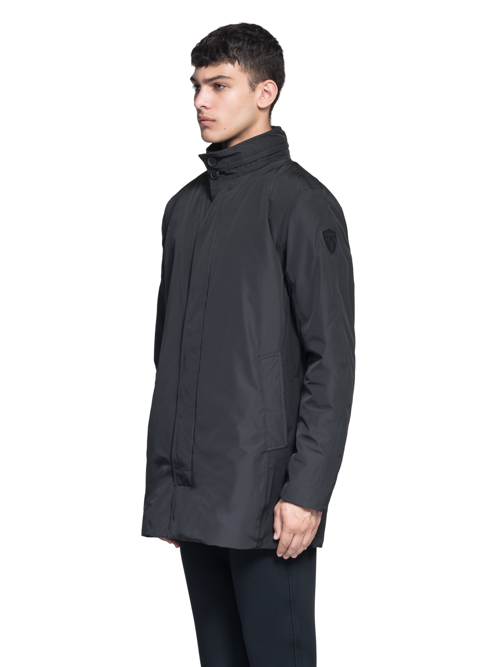 Pike Men's Tailored Mac Coat in thigh length, premium 3-ply Micro Denier fabrication at body and cire technical nylon taffeta fabrication at hood, premium 4-way stretch, water resistant Primaloft Gold Insulation Active+, hidden 2-way zipper with snap closure wind flap, single welt pockets with magnetic closure at waist, hidden snap placket at cuffs, pit zippers for ventilation, interior zipper pocket at right chest, and interior button pocket at left chest, in Black