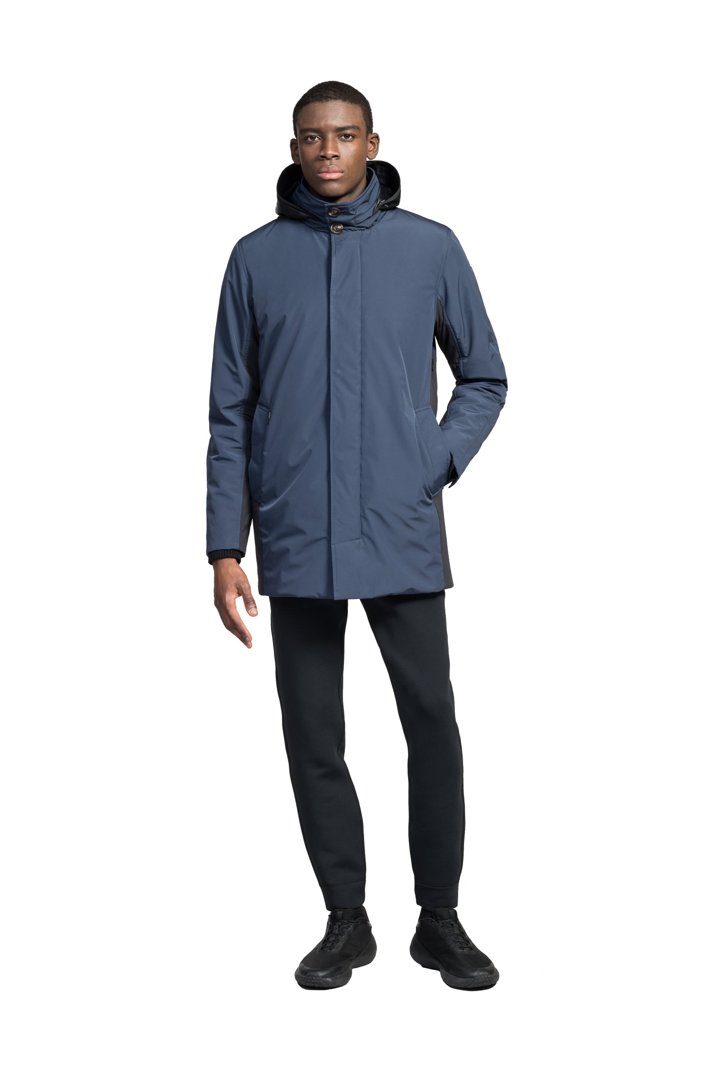 Pike Men's Tailored Mac Coat in thigh length, premium 3-ply Micro Denier fabrication at body and cire technical nylon taffeta fabrication at hood, premium 4-way stretch, water resistant Primaloft Gold Insulation Active+, hidden 2-way zipper with snap closure wind flap, single welt pockets with magnetic closure at waist, hidden snap placket at cuffs, pit zippers for ventilation, interior zipper pocket at right chest, and interior button pocket at left chest, in Marine