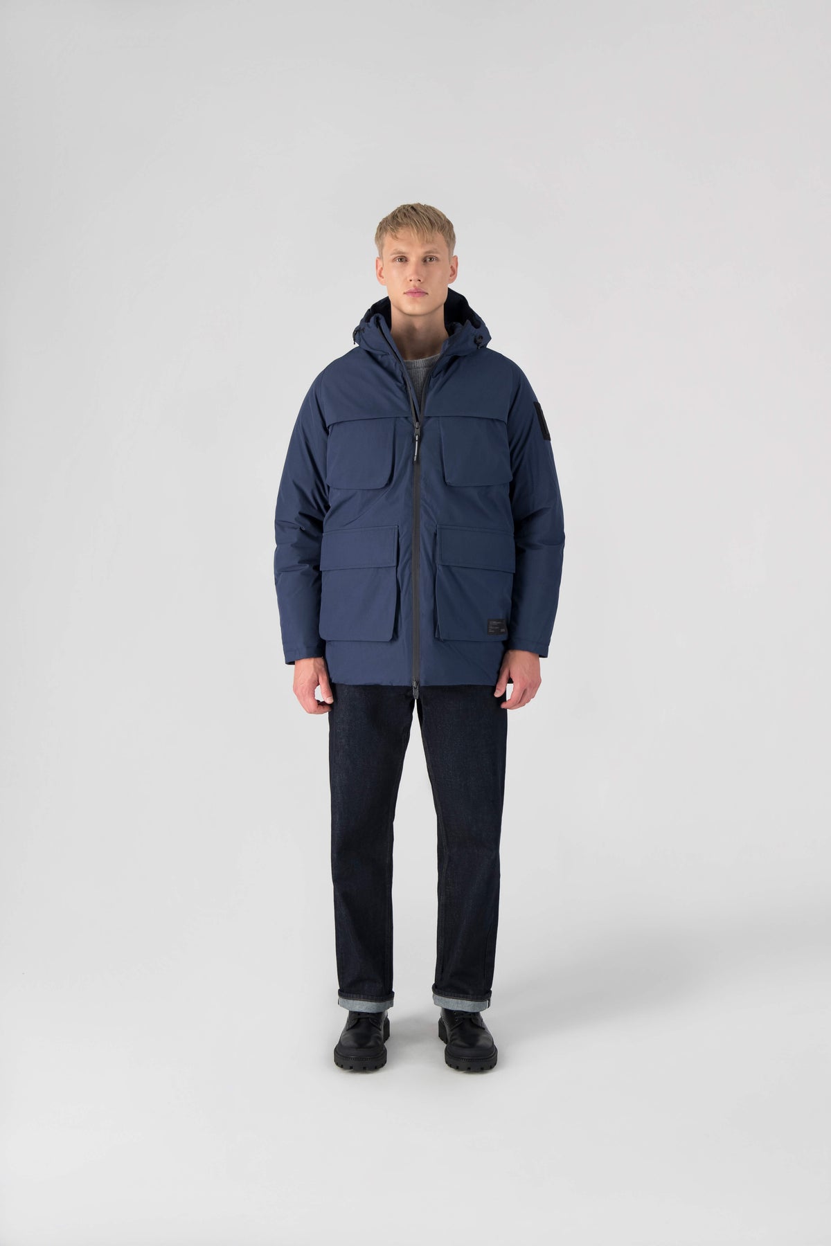 Ronin Men's Performance Utility Jacket in thigh length, premium 3-ply micro denier and stretch ripstop fabrication, Premium Canadian origin White Duck Down insulation, non-removable down-filled hood, bellow chest pockets, magnetic closure waist flap pockets, two-way centre-front zipper, pit zipper vents, hidden adjustable waist drawcord, in Marine