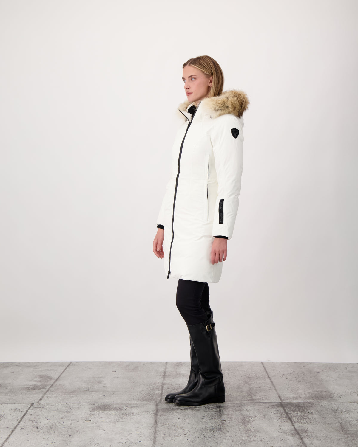 Ladies thigh length down-filled parka with non-removable hood and removable coyote fur trim in Chalk