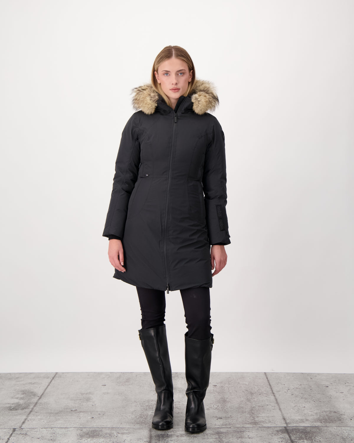 Ladies thigh length down-filled parka with non-removable hood and removable coyote fur trim in Black