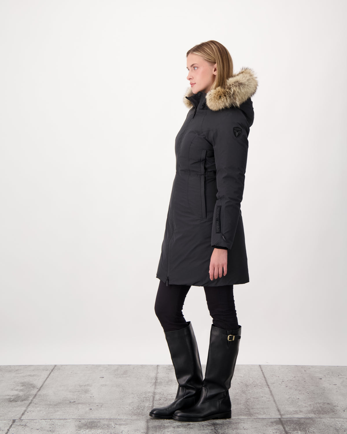 Ladies thigh length down-filled parka with non-removable hood and removable coyote fur trim in Black