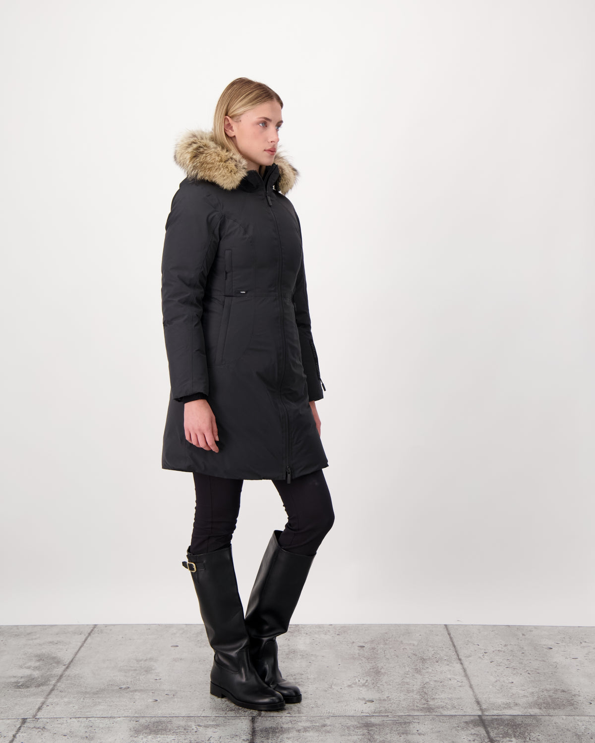 Ladies thigh length down-filled parka with non-removable hood and removable coyote fur trim in Black