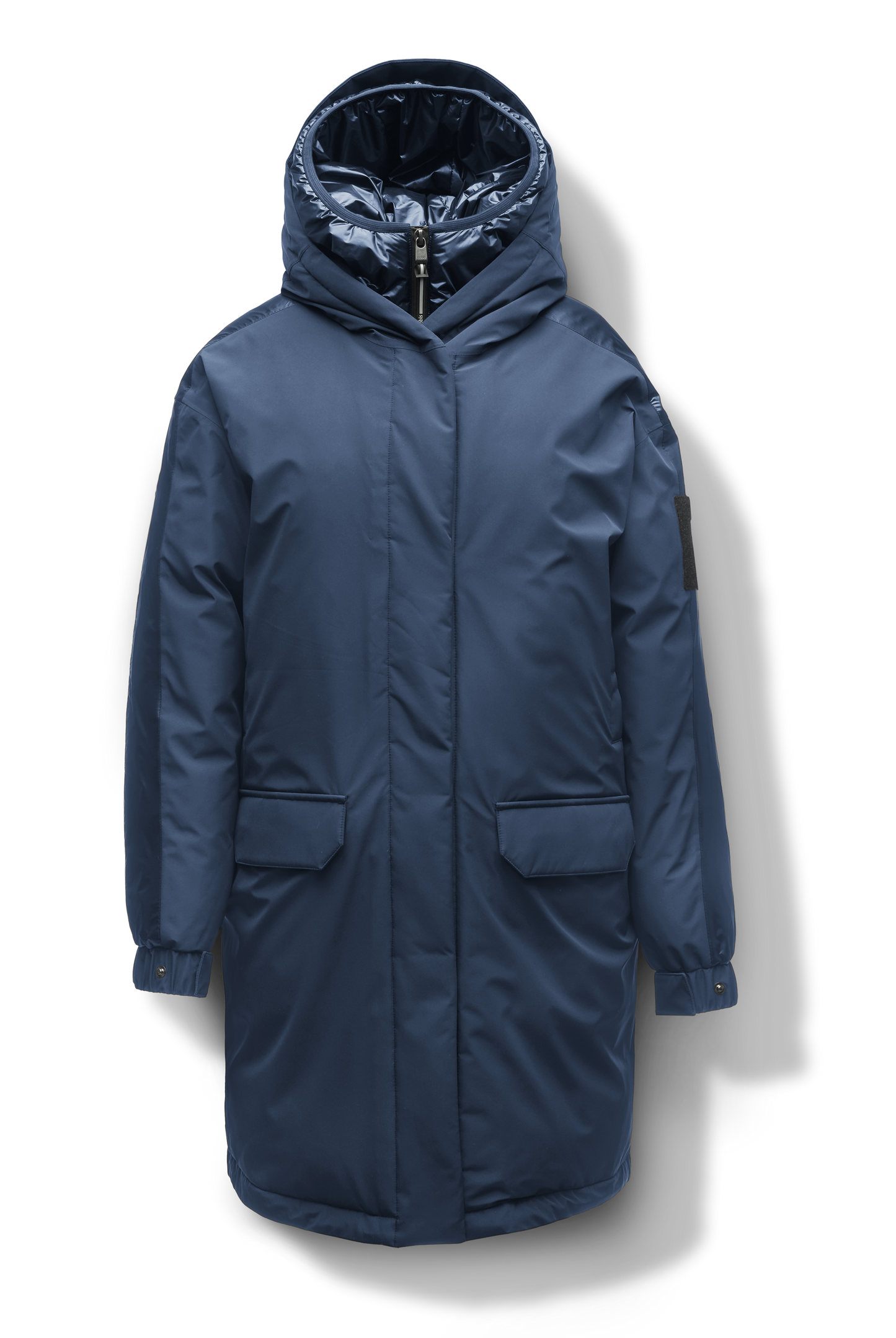 Slyn Women's Performance Parka in thigh length, premium 3-ply micro denier and cire technical nylon taffeta fabrication, Premium Canadian origin White Duck Down insulation, non-removable down-filled hood, inner hooded gilet, two-way centre-front zipper with magnetic closure wind flap, fleece-lined pockets at chest and waist, pit zipper vents, in Marine