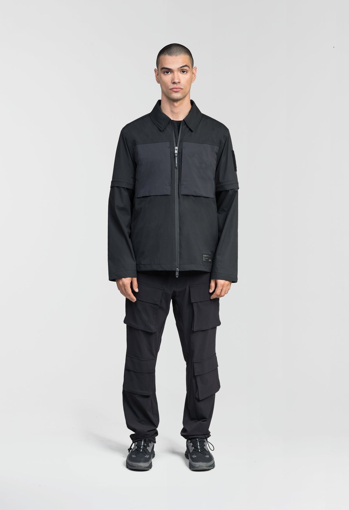 Thurlow Men's Performance Zip Off Sleeve Rain Shirt in hip length, convertible collar, patch chest zipper pockets, hidden in-seam pockets, zip off sleeves, centre front two-way zipper closure, in Black