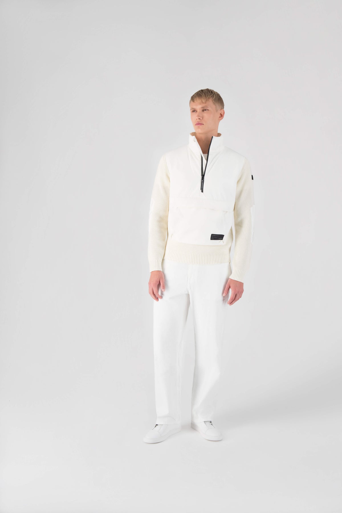 Wai Men's Performance Half Zip Sweater in hip length, 3-Ply Micro Denier and Merino wool knit fabrication, Primaloft Gold Insulation Active+, centre front zipper, flap kangaroo pocket with magnetic closure, and hidden side-entry zipper pockets at waist, in Chalk
