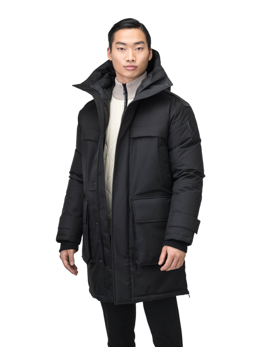 Alum Men's Long Parka in thigh length, Premium Canadian White Duck Down insulation, non-removable hood with removable coyote fur trim, two-way centre front zipper with magnetic closure wind flap, four exterior patch pockets at front, in Black