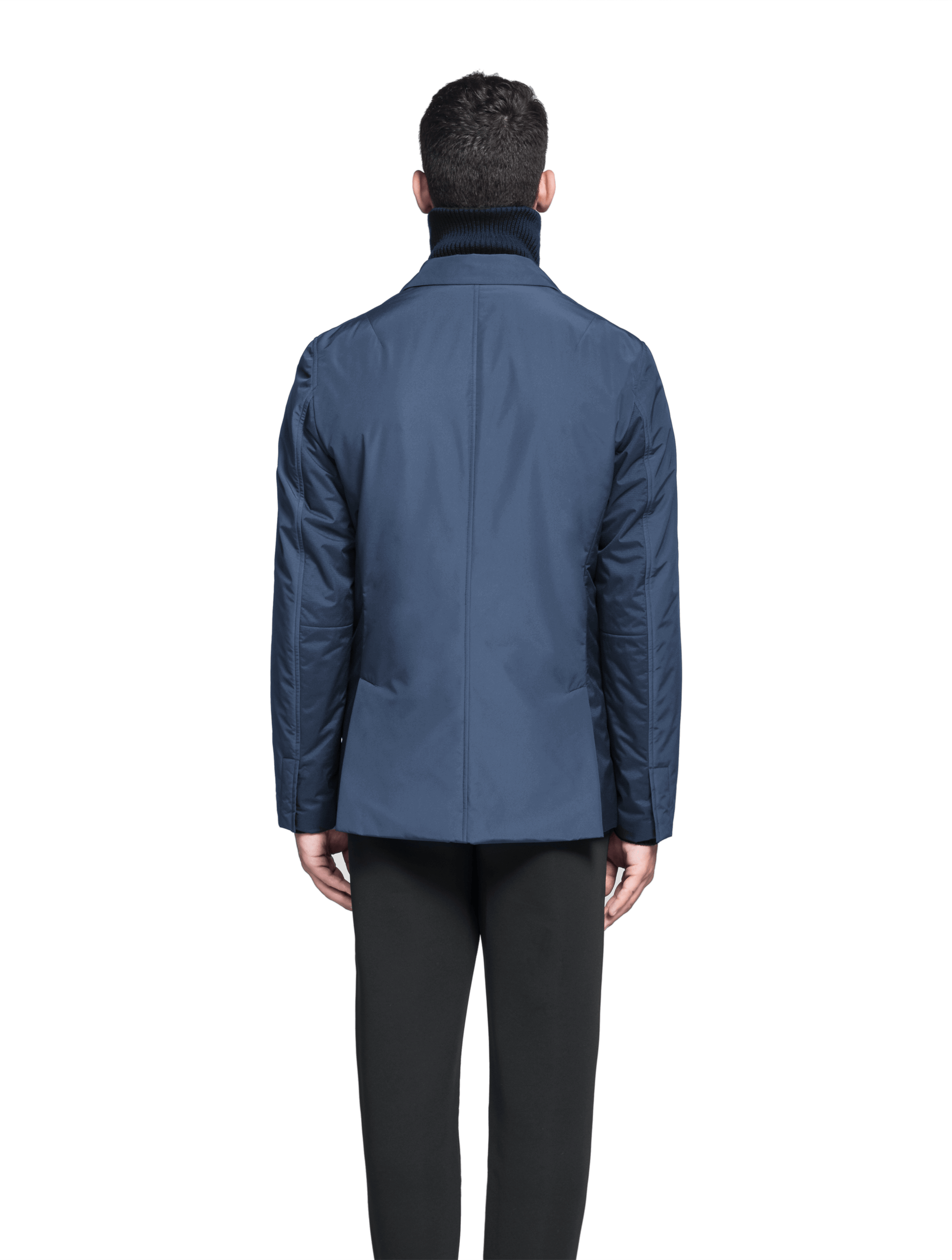 Cody Men's Tailored Travel Blazer in 3-ply micro denier and stretch nylon fabrication with DWR coating, Primaloft Gold Insulation Active+, hidden two-way zipper at centre front with snap closure placket, three invisible exterior zipper pockets, double back pleats, and hidden snap placket at cuffs, in Marine