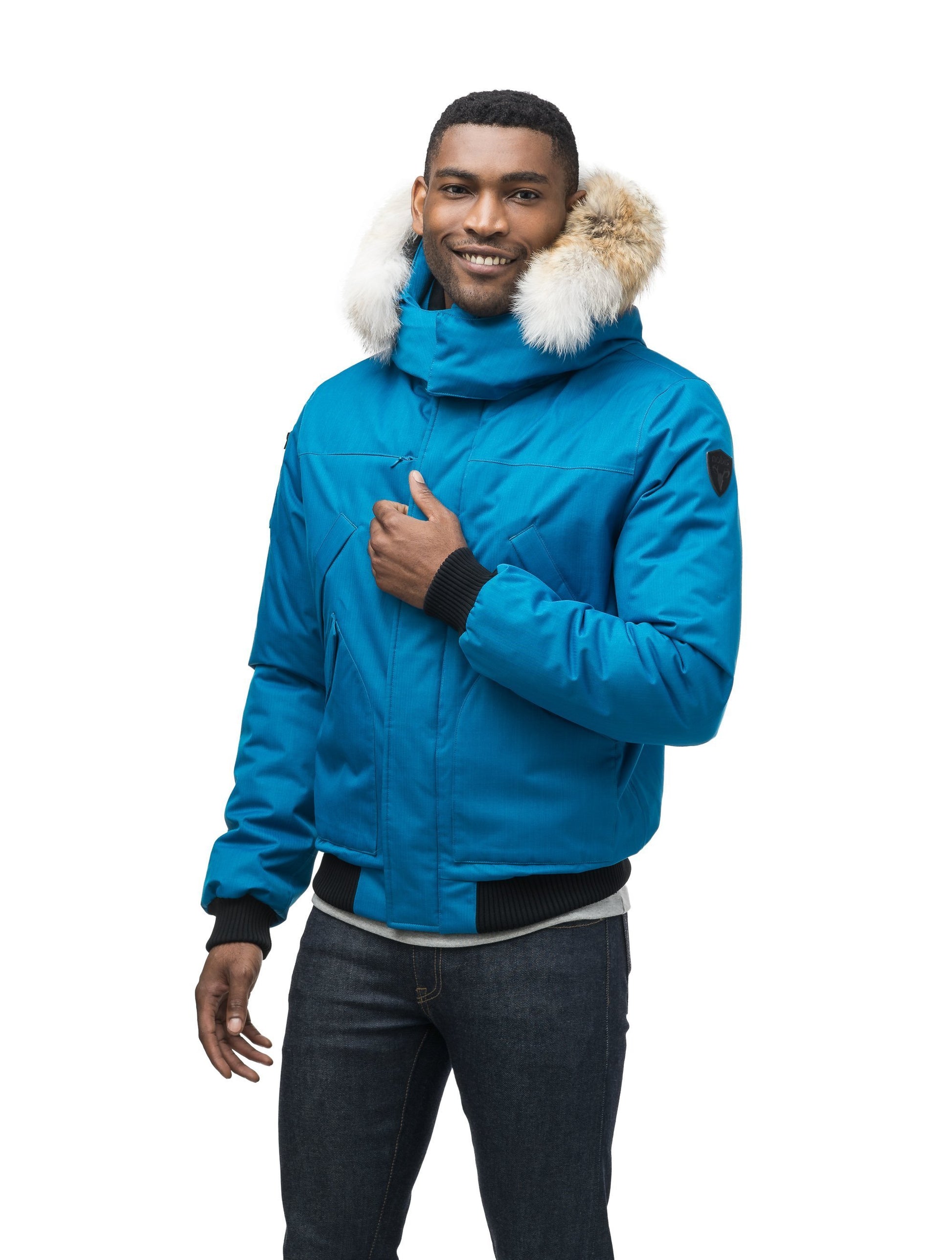 Men's classic down filled bomber jacket with a down filledÃ‚Â hood that features a removable coyote fur trim and concealed moldable framing wire in Sea Blue