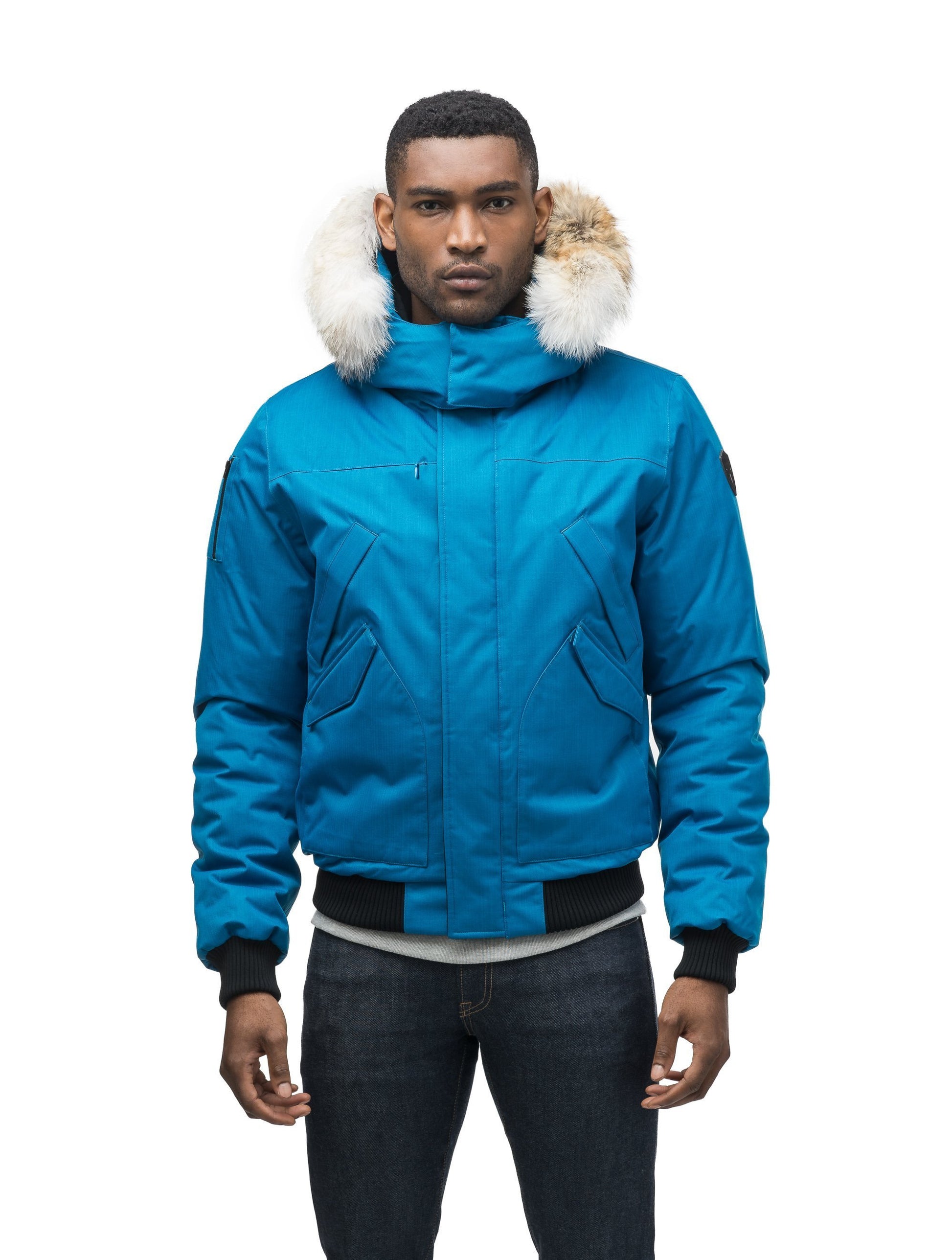 Men's classic down filled bomber jacket with a down filledÃƒÆ’Ã¢â‚¬Å¡Ãƒâ€šÃ‚Â hood that features a removable coyote fur trim and concealed moldable framing wire in Sea Blue
