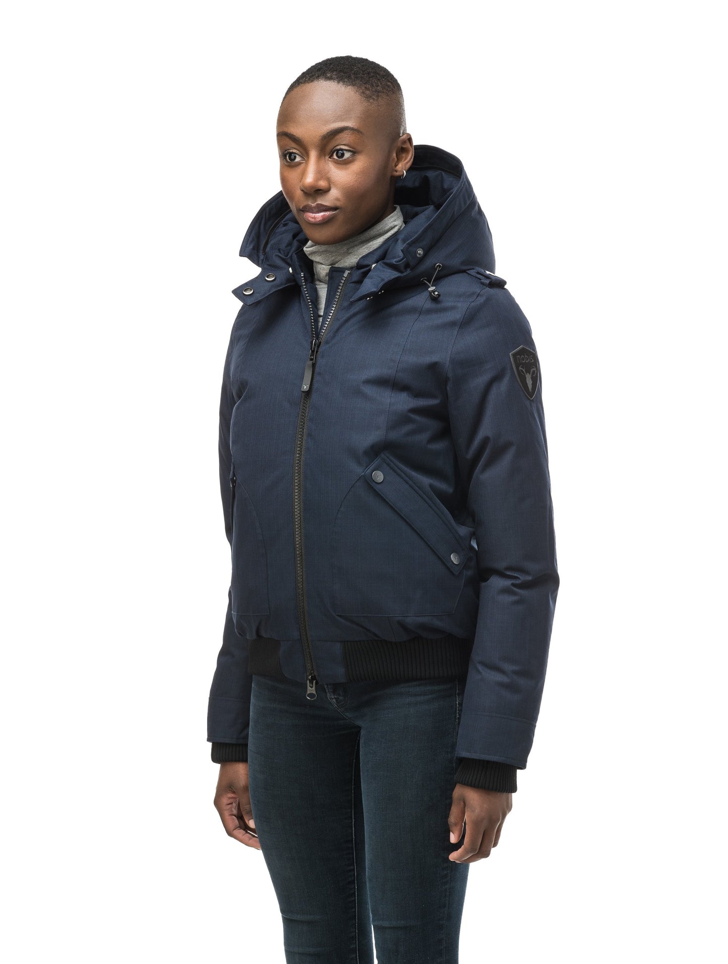 Women's bomber style down filled jacket with a removable hood and fur trim in CH Navy