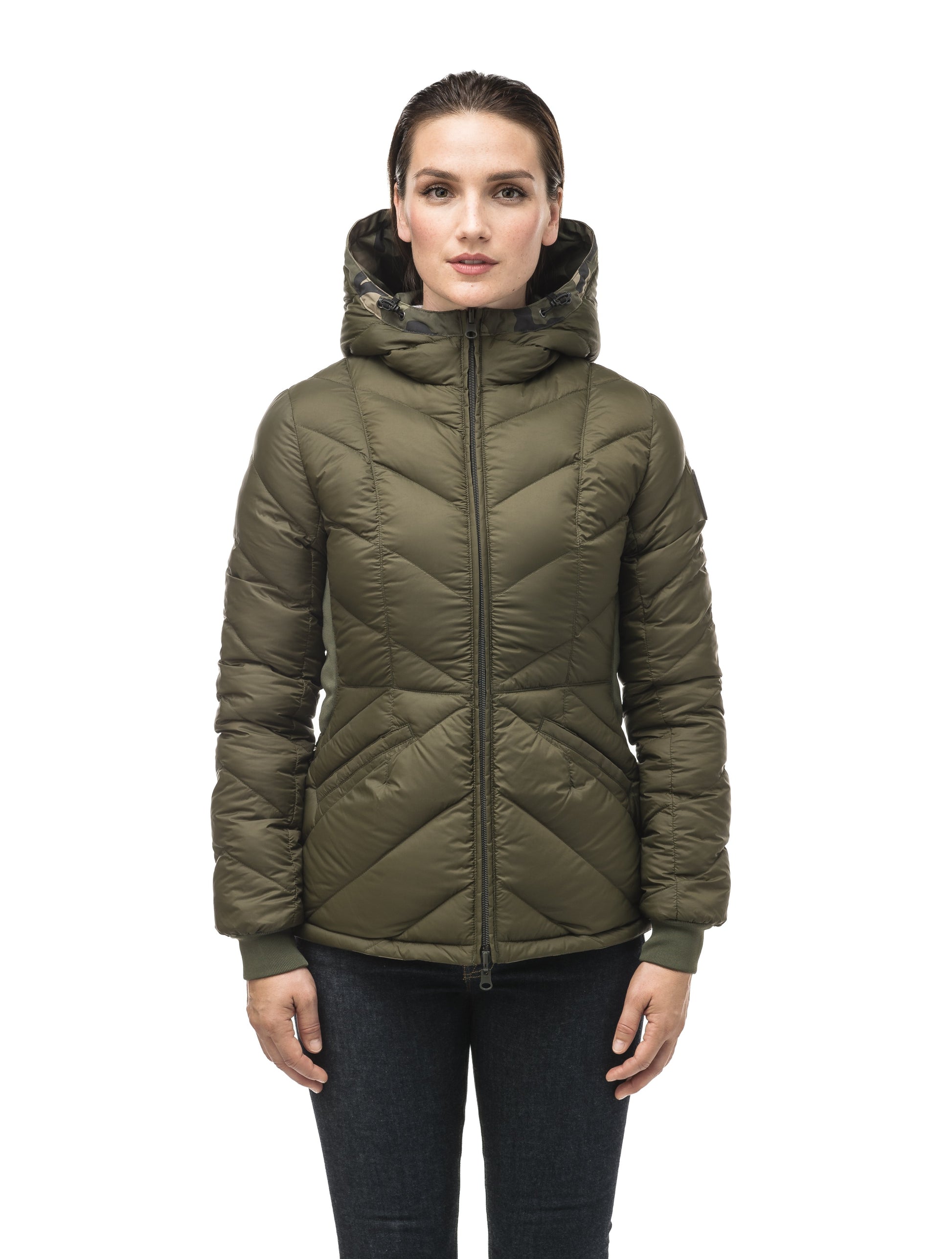 A women's two in one reversible hip length down jacket, one side is quilted and one side is solid waterproof fabric in Camo