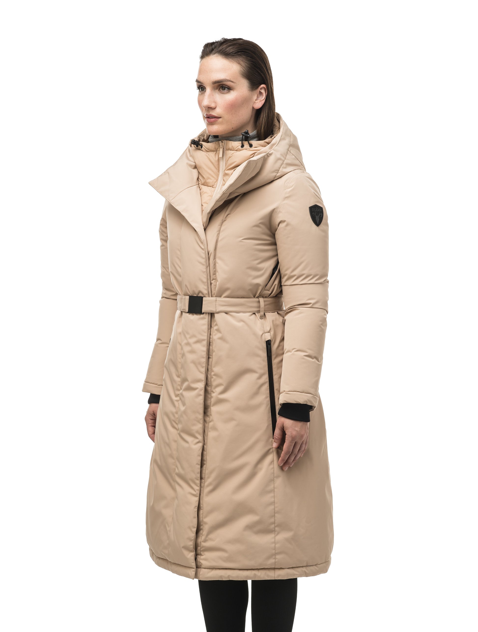 Long calf length hooded women's winter parka with an inner hip length closure, exterior hem length zipper and magentic placket in Fawn