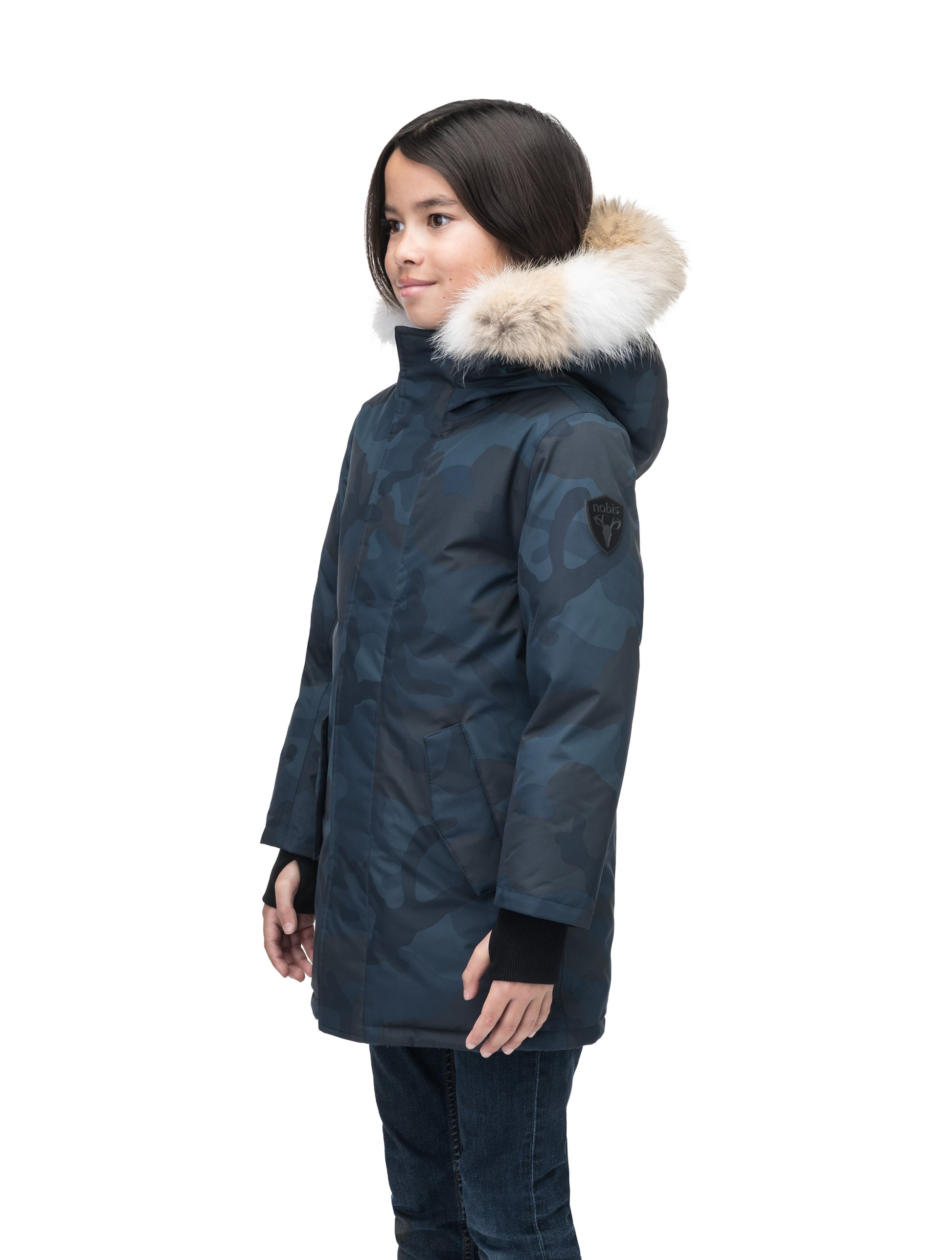 Kids' thigh length down-filled parka with non-removable hood and removable coyote fur trim in Navy Camo