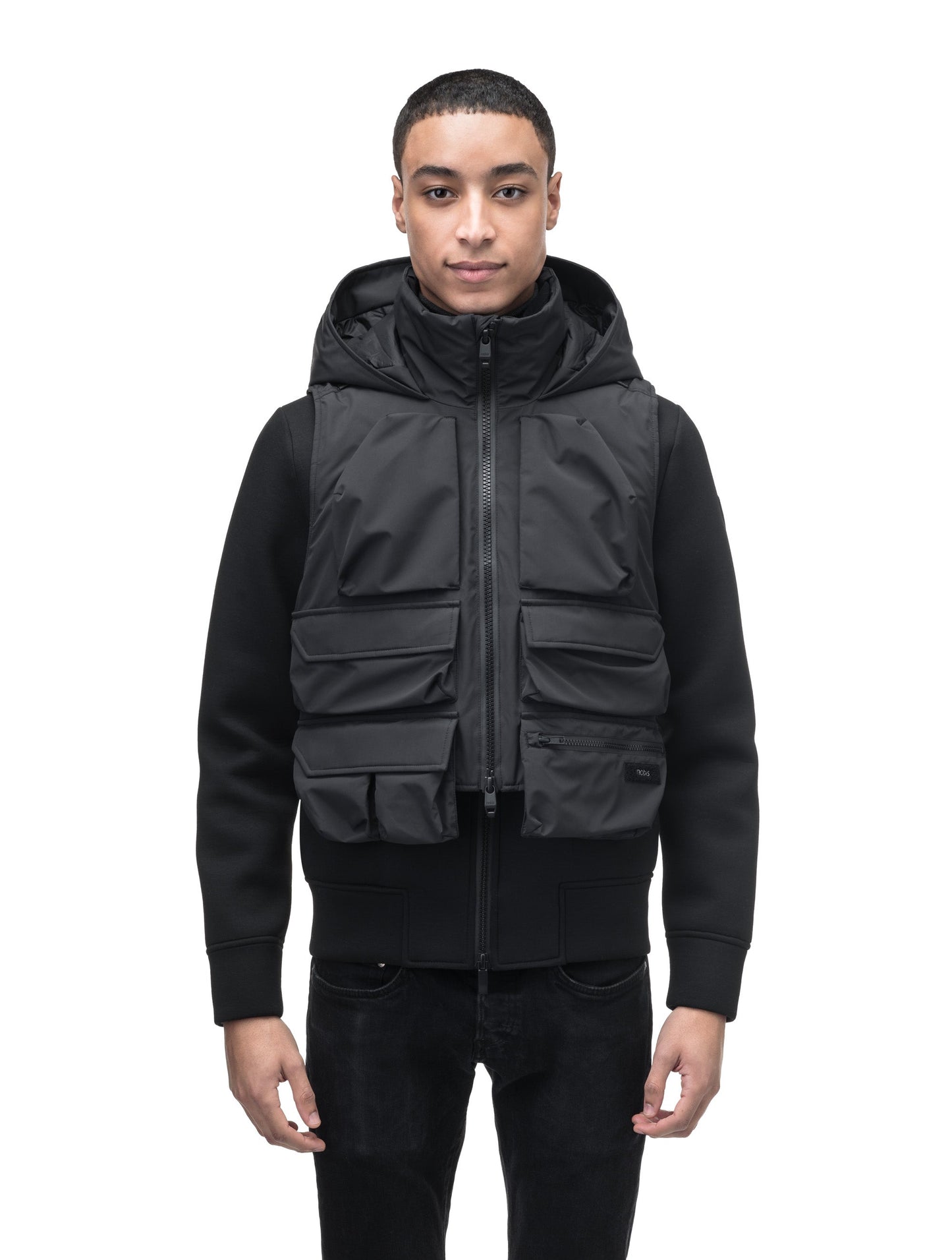 Vulcan Unisex Tactical Vest in waist length, Primaloft Gold Insulation Active, non-removable hood, removable face mask, seven pockets on front and back, and two-way front zipper, in Black