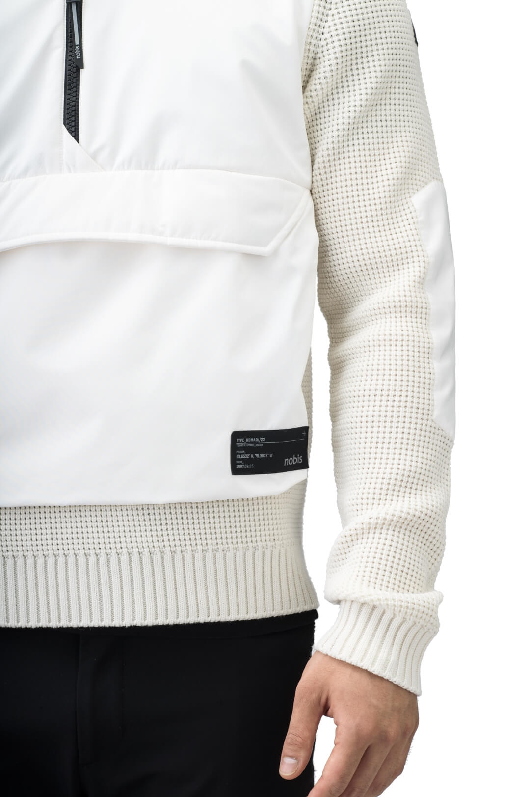 Wai Men's Performance Half Zip Sweater in hip length, 3-Ply Micro Denier and Merino wool knit fabrication, Primaloft Gold Insulation Active+, centre front zipper, flap kangaroo pocket with magnetic closure, and hidden side-entry zipper pockets at waist, in Chalk