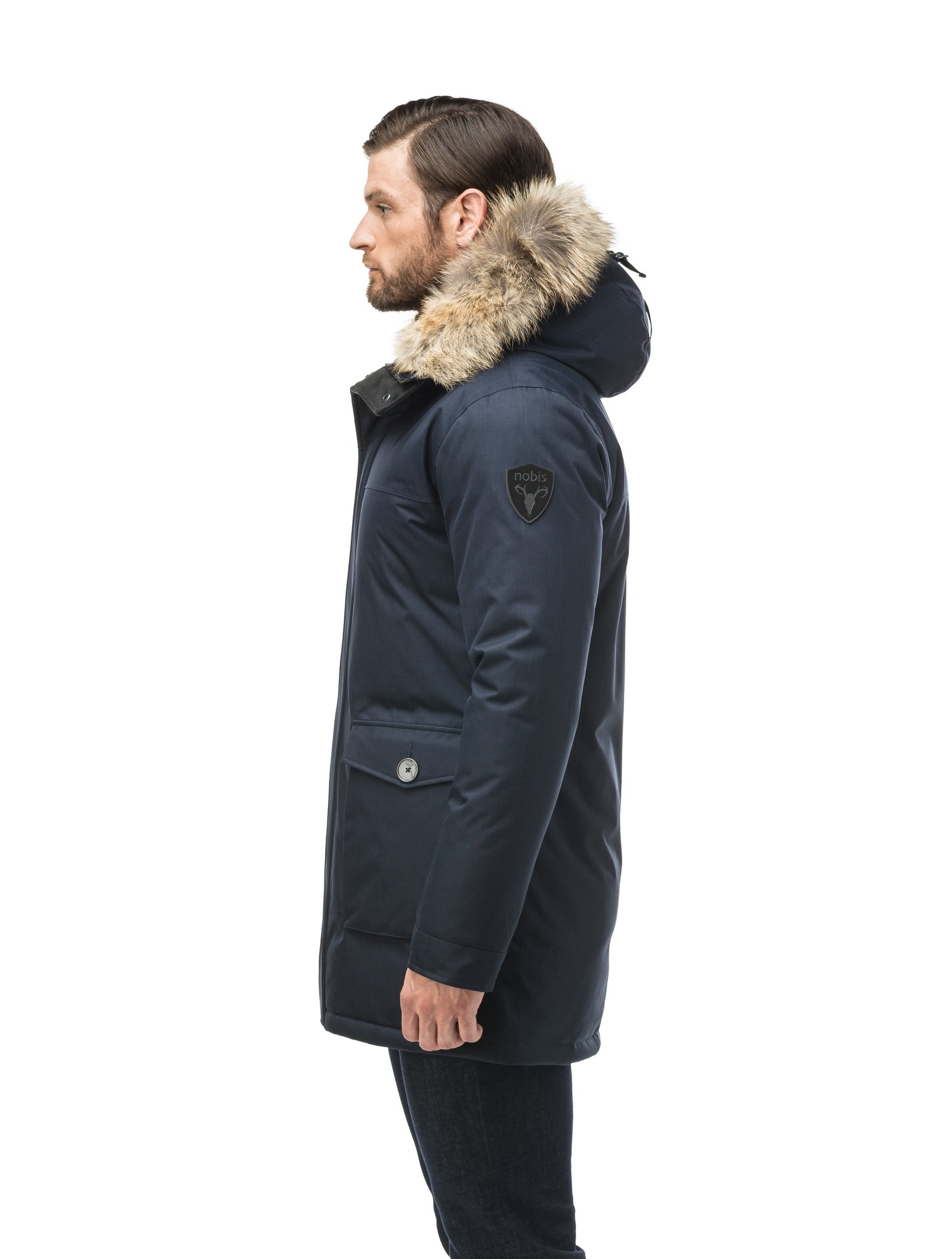 Men's slim fitting waist length parka with removable fur trim on the hood and two waist patch pockets in CH Navy