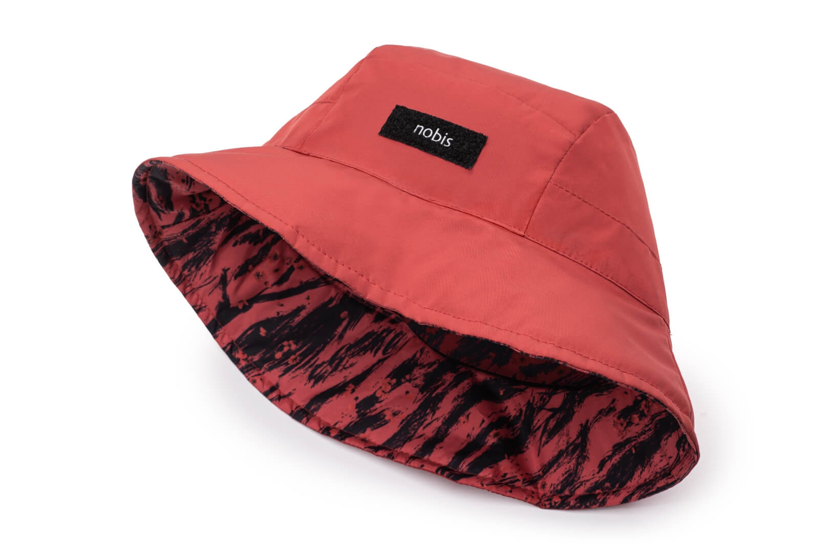 Lunar New Year Reversible Bucket Hat with one side in red tiger print, and the reverse side in tonal red with Nobis label branding on the crown front, in Vermillion